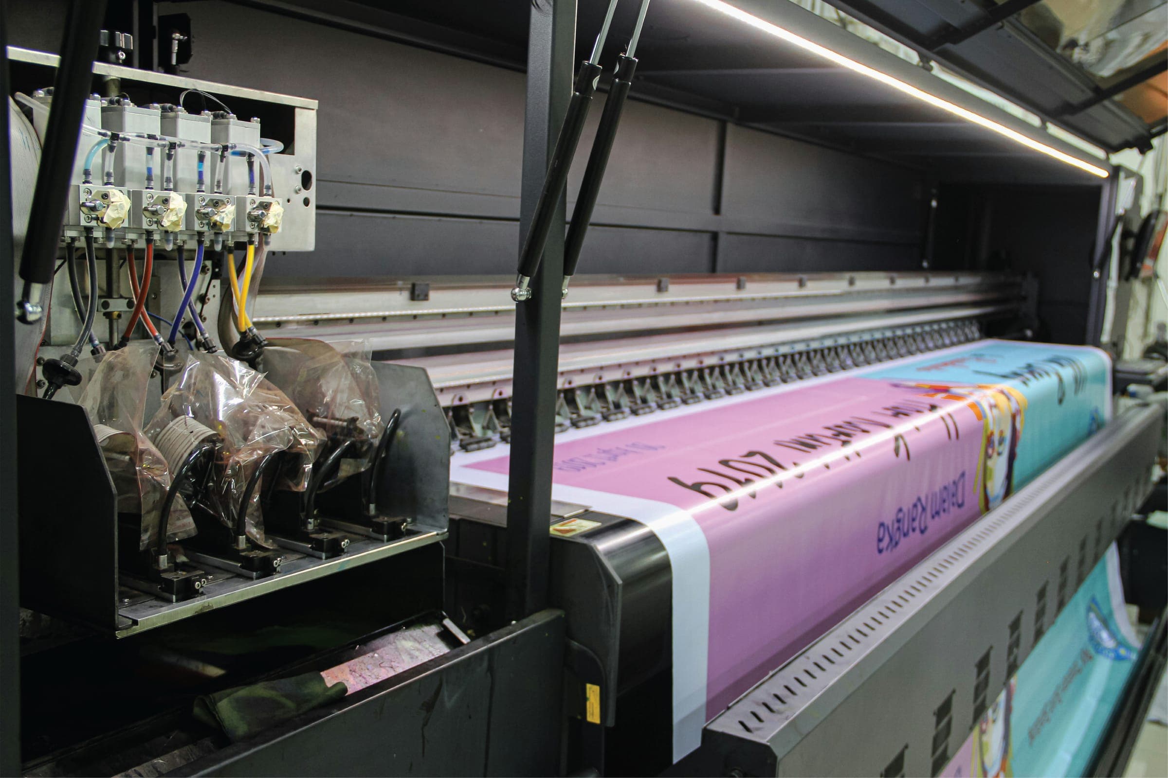 Our wide-format printer printing a long banner in the workshop