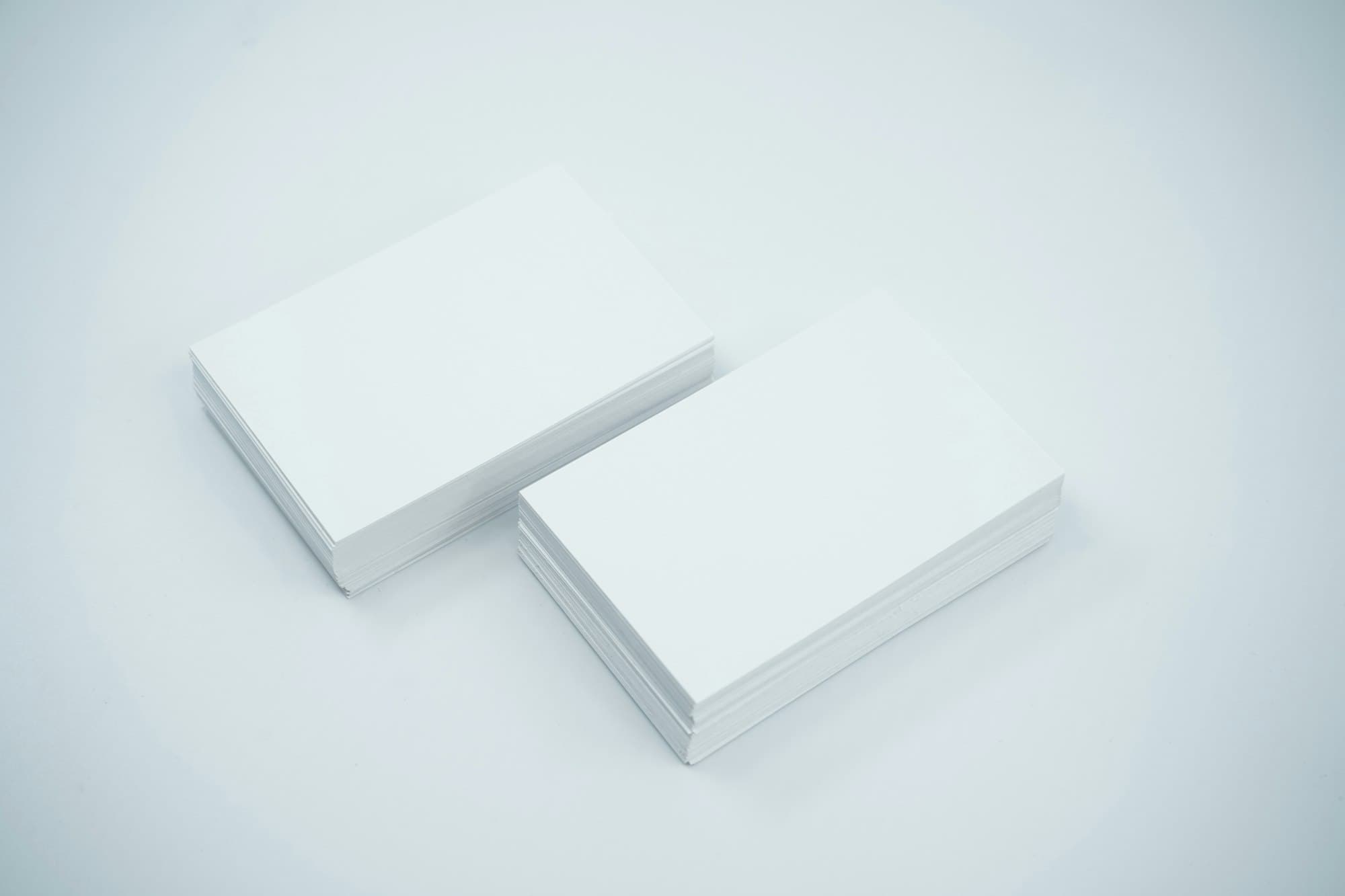 Two stacks of business cards