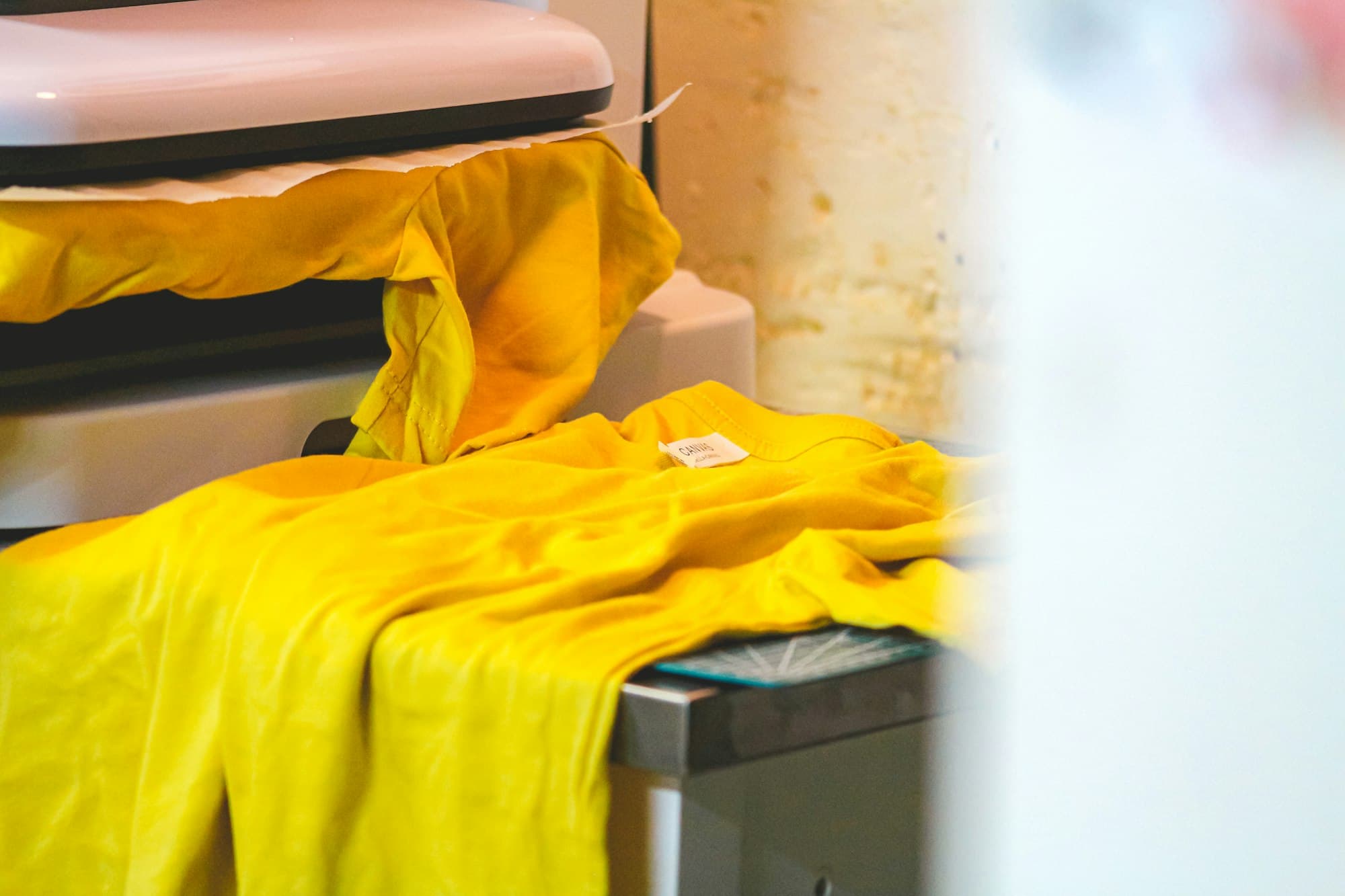 A yellow t-shirt on the press