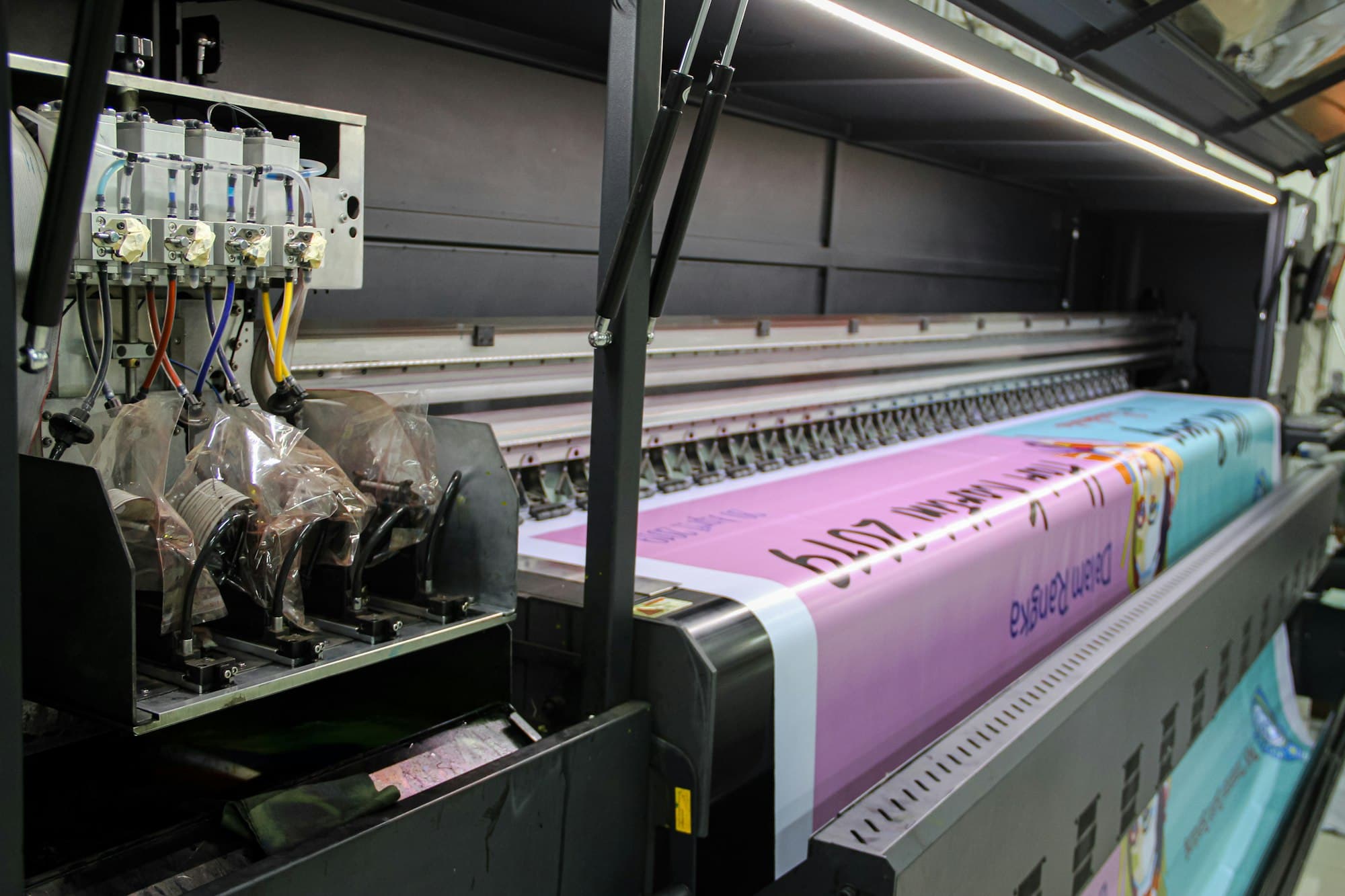 Our wide-format printer feeding out a printed banner