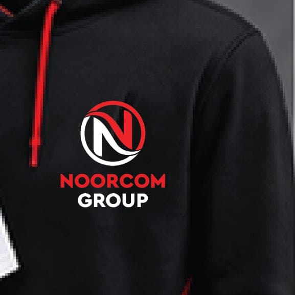 A black hoodie with a red hood lining and the Noorcom Group logo on the chest