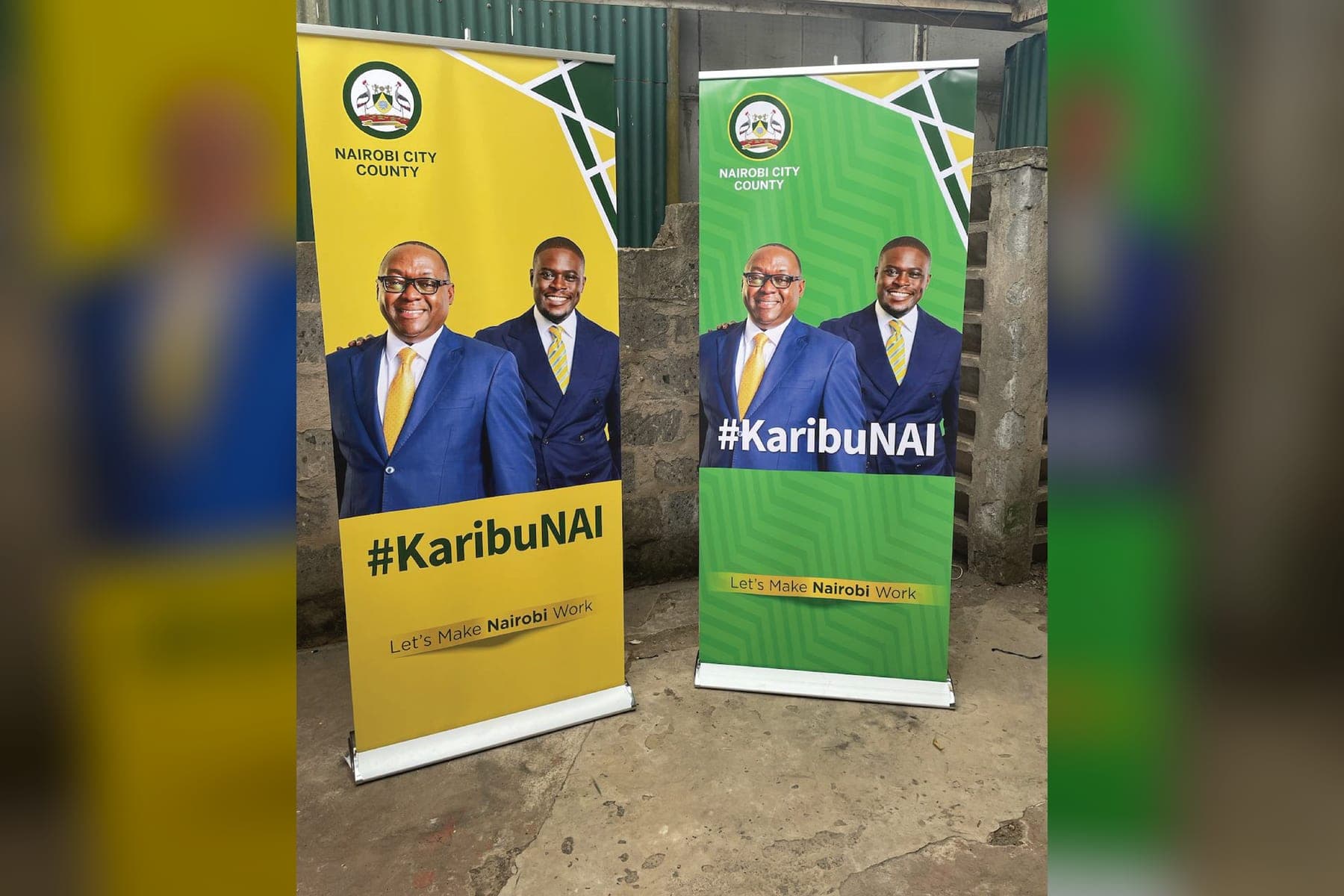 Two #KaribuNAI roll-up banners, one yellow and one green